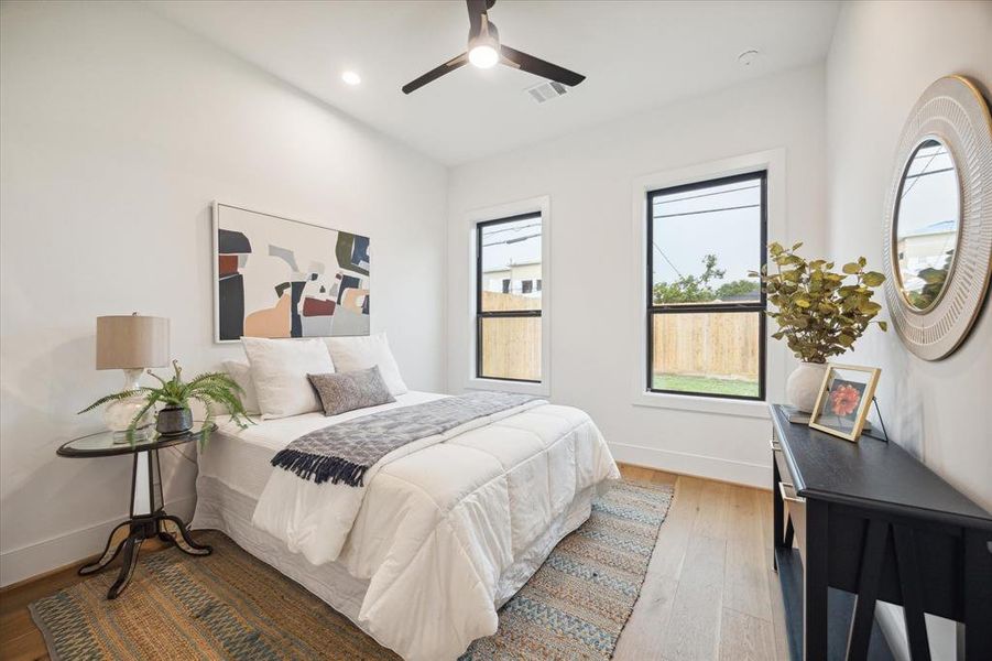 The secondary bedroom on the first floor overlooks the backyard.