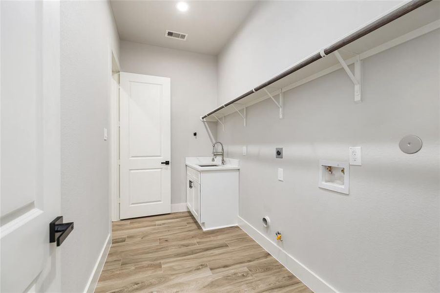 The innovative Utility Room has a convenient laundry chute from the second floor directly into the laundry room, and also features a sink, simplifying household chores, plus access straight into the primary closet.