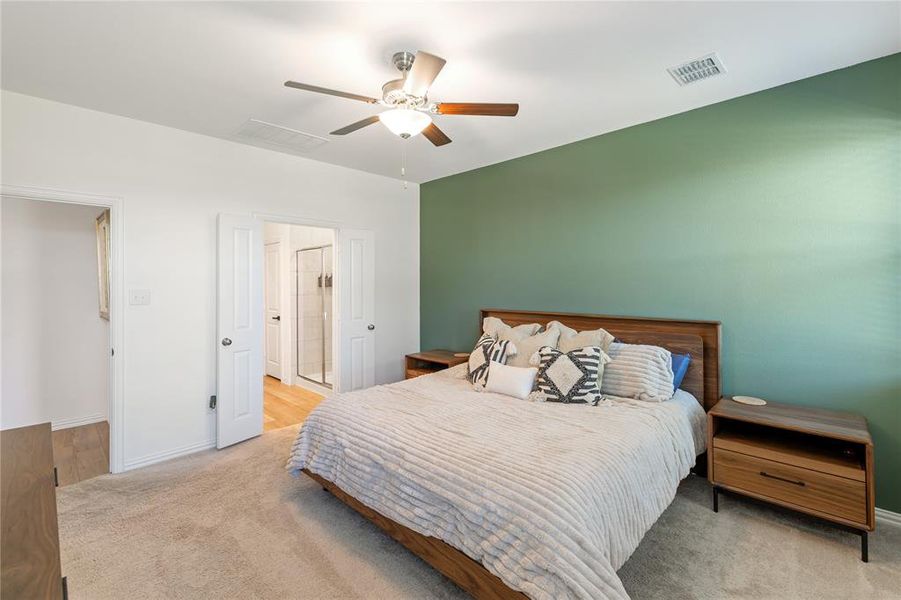 Carpeted bedroom with ceiling fan