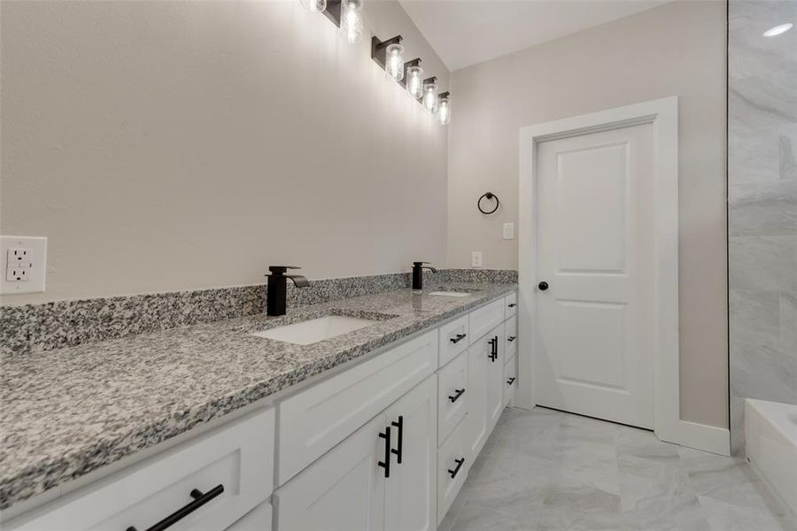 Bathroom with dual bowl vanity and tile flooring