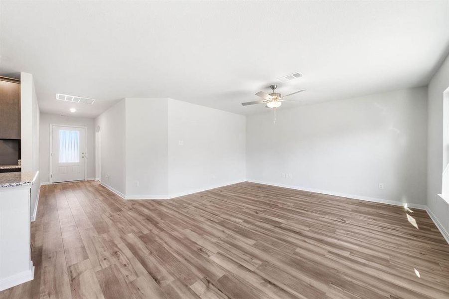 Spare room featuring ceiling fan and light hardwood / wood-style floors