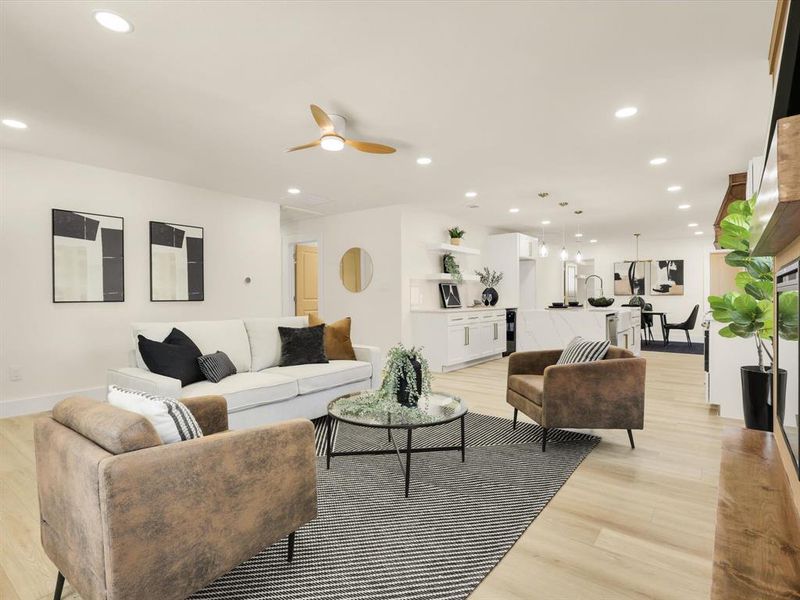 Living room with ceiling fan and light wood-type flooring