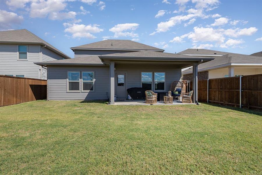 Back of house with a patio area and a yard