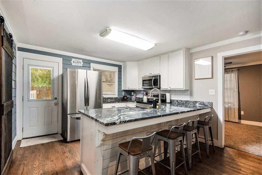 Granite countertops and subway tile have updated this kitchen.