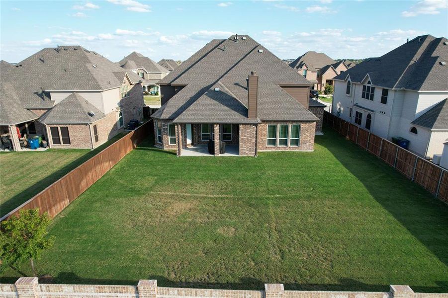 Back of property featuring a patio and a lawn