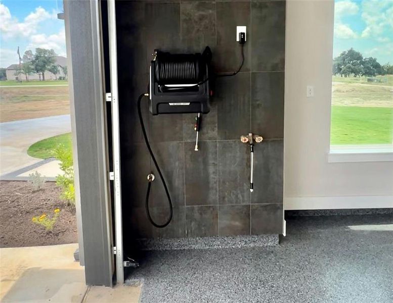 Built-in electric 100ft pressure washer station, hot and cold water.  Easily wash down cars, toys, lawn equipt. in seconds.