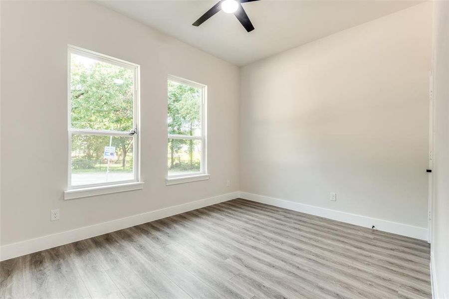 Empty room with hardwood / wood-style flooring and ceiling fan