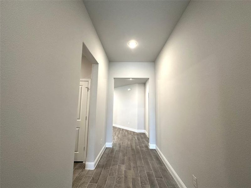 Hall with dark hardwood / wood-style floors