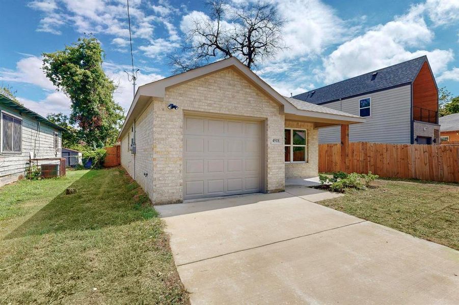 View of front of property featuring central AC unit and a front lawn