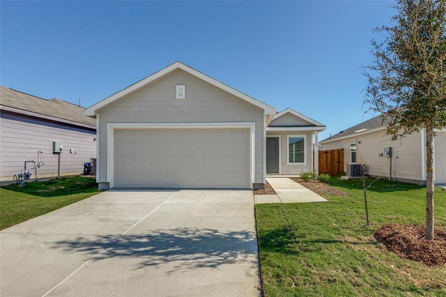 Ranch-style house featuring central AC unit, a garage, and a front yard