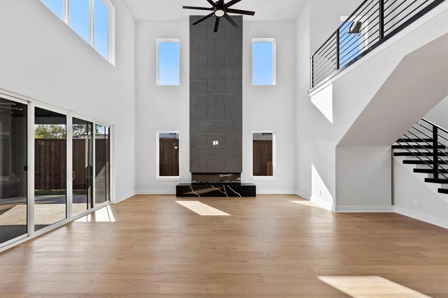 Unfurnished living room with plenty of natural light and a high ceiling