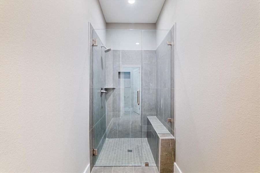 Bathroom featuring a shower with door