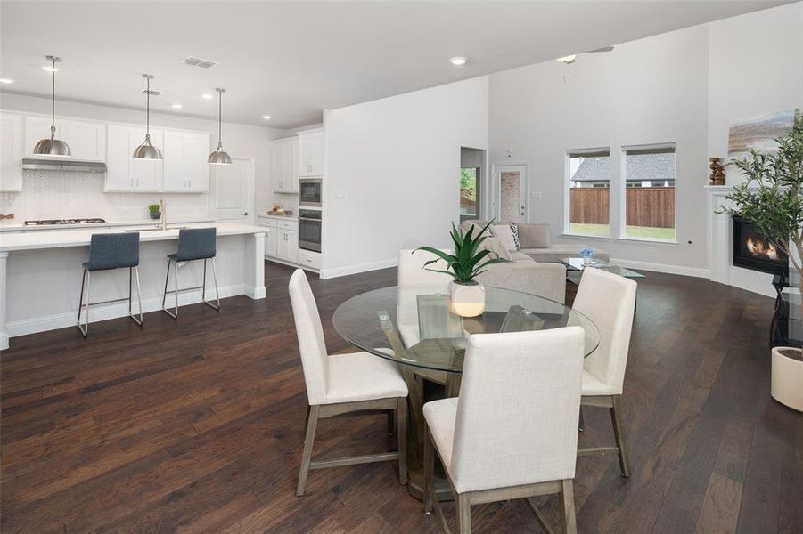 Dining room with dark hardwood / wood-style floors and sink