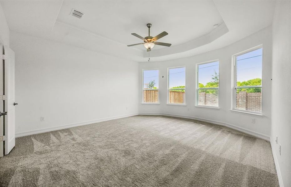 Elegant owner's suite with bay window *real home pictured