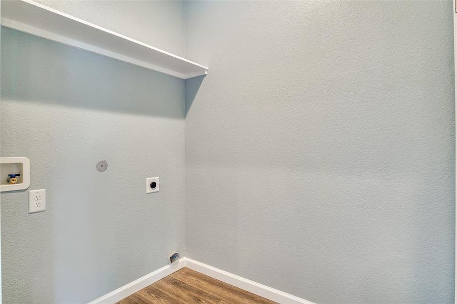 Laundry area with hookup for a washing machine, electric dryer hookup, and hardwood / wood-style floors