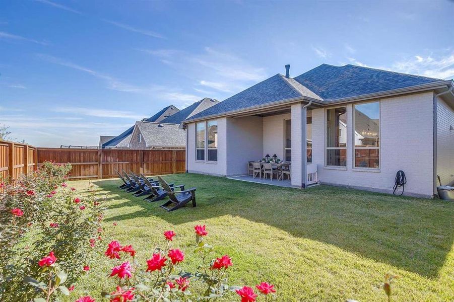 Back of property featuring a patio area and a yard