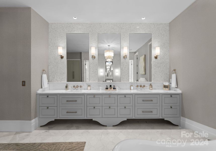 Stunning marble countertops, wall mounted fixtures, custom cabinetry, ample storage, and beautiful sconces.