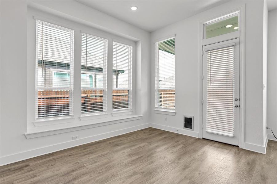 Spare room featuring wood-type flooring