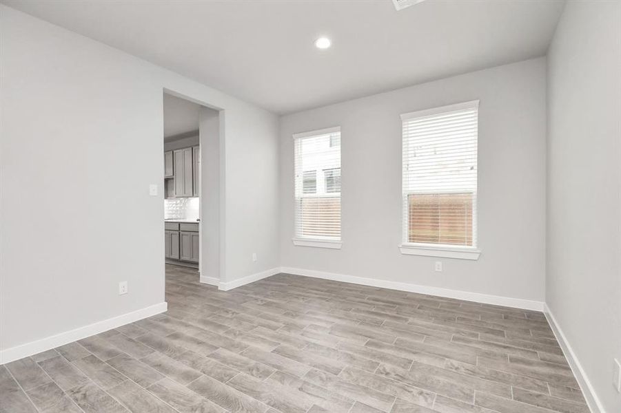 Make memories gathered around the table with your family and friends! This dining spacious room features elegant flooring, custom paint, and adjacent to kitchen for open concept feel. Sample photo of completed home with similar floor plan. As-built interior colors and selections may vary.