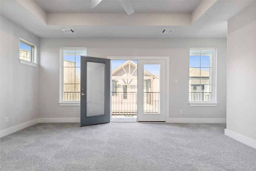 Unfurnished room with carpet floors and a raised ceiling