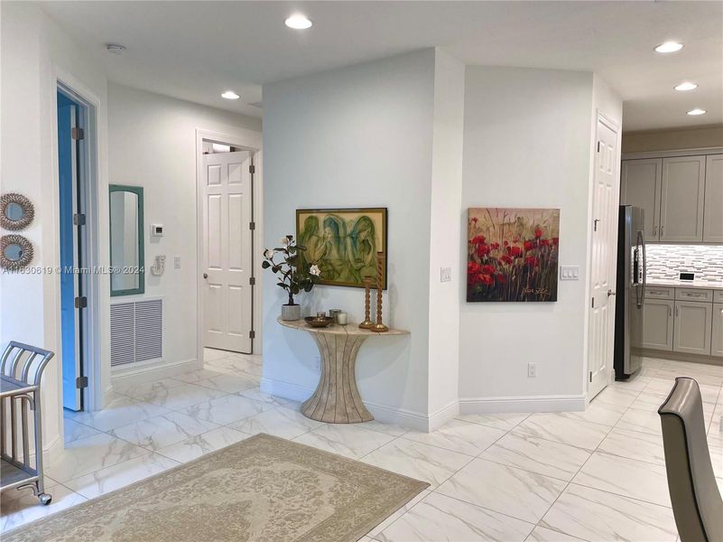 Looking toward the den/office and hallway leading to the second bedroom, second bathroom, and laundry room