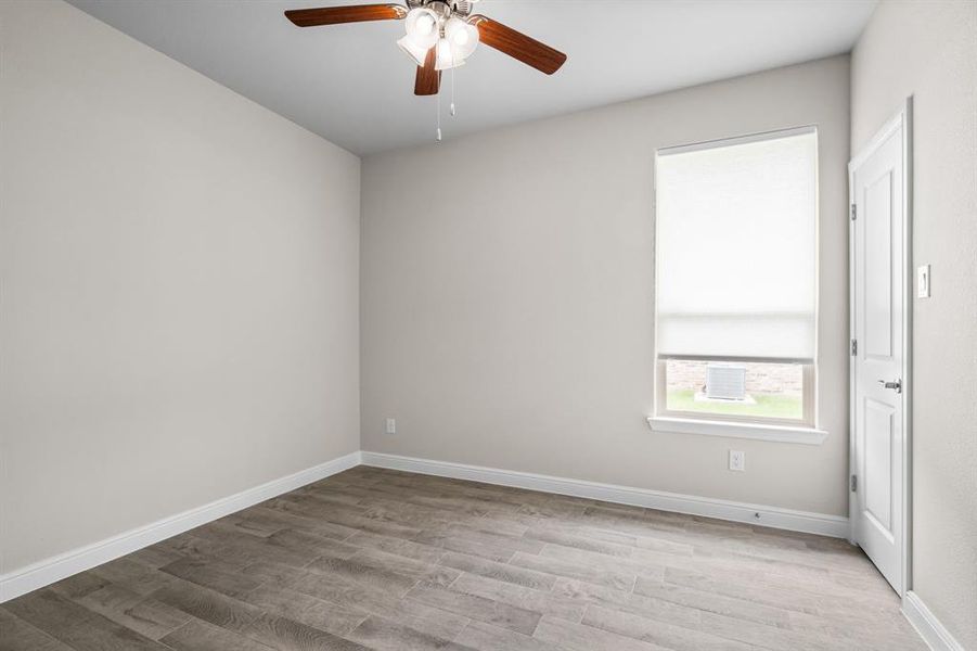 Third bedroom boasts neutral paint colors and wood-look flooring!