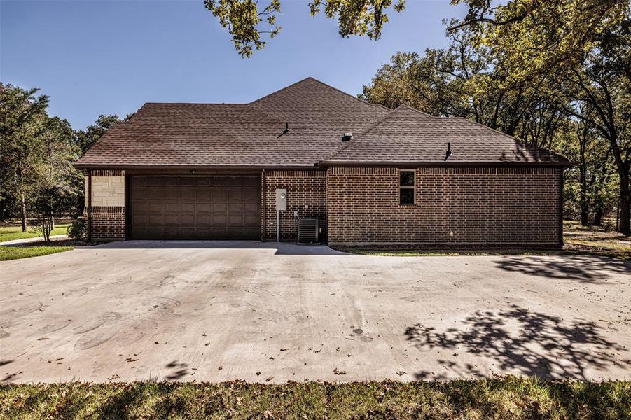 View of property exterior featuring a garage