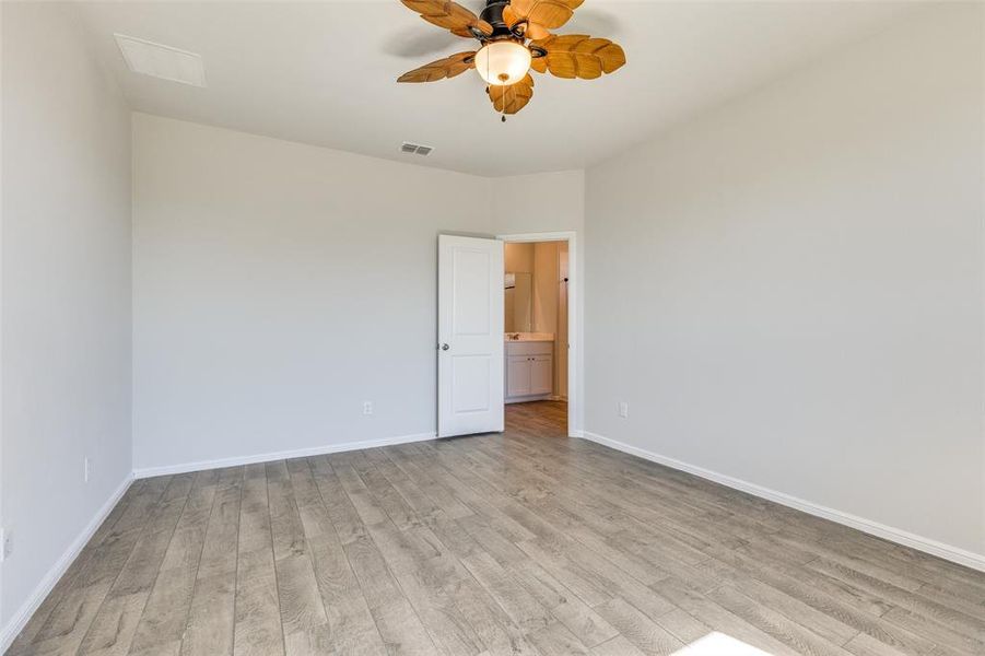 Spare room featuring ceiling fan and light hardwood / wood-style flooring