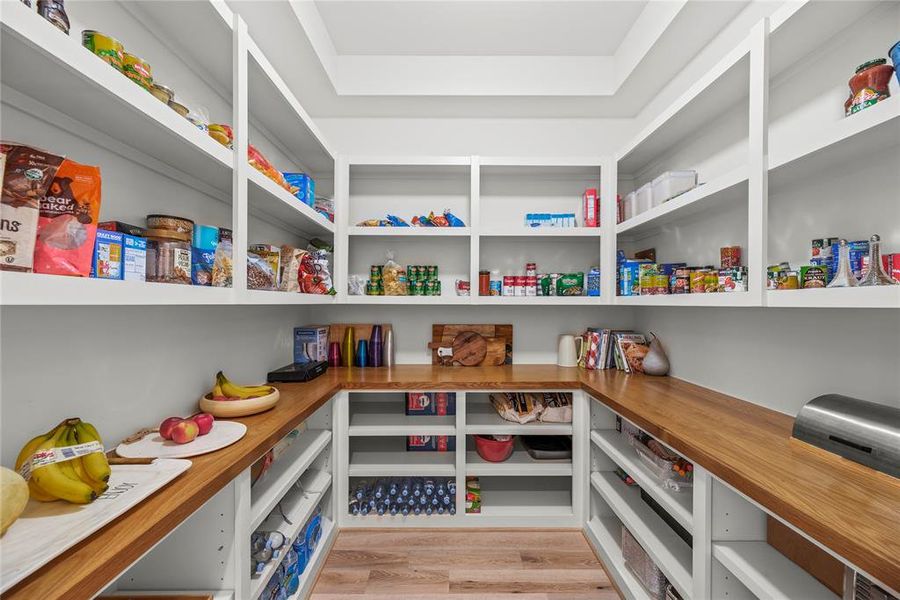 How is this for a walk-in pantry.  Custom shelving to keep everything organized.