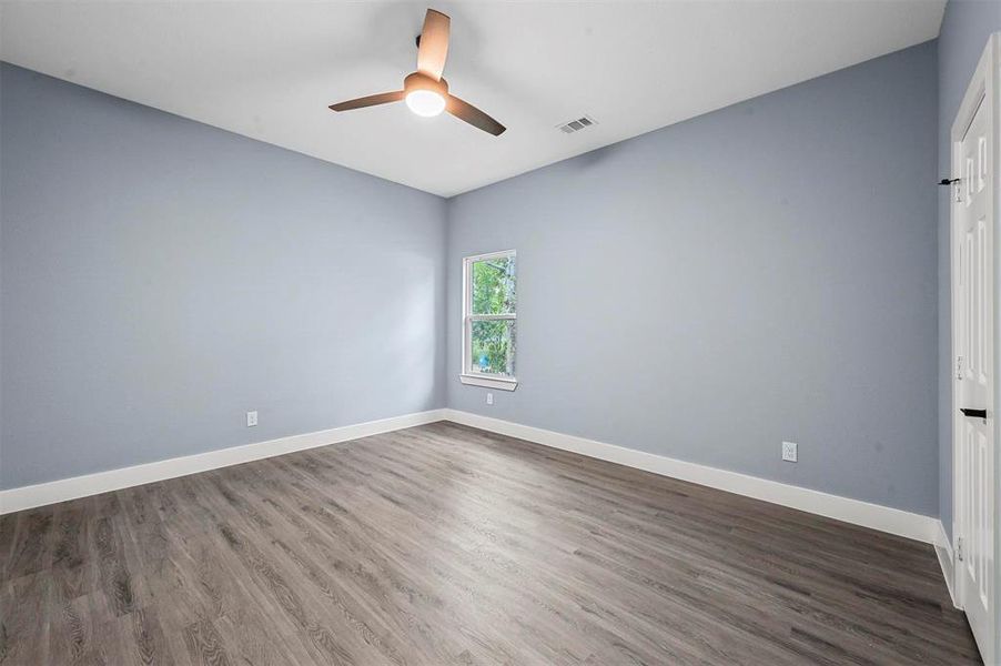 Spare room featuring ceiling fan and dark hardwood / wood-style floors