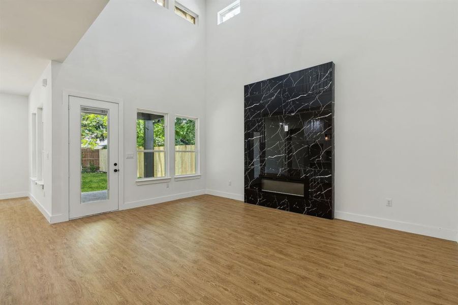 Unfurnished living room with light hardwood / wood-style floors and a fireplace