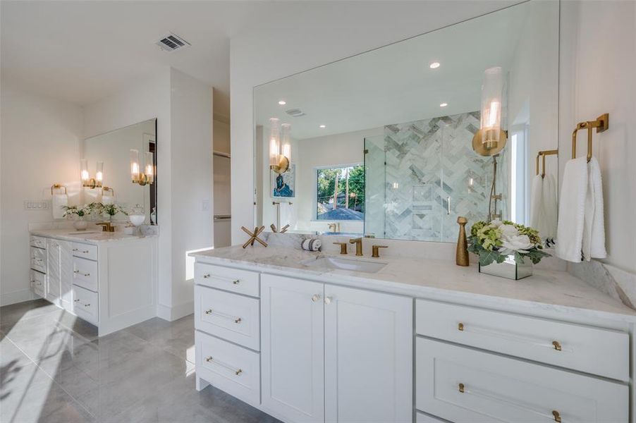 Bathroom featuring walk in shower and vanity