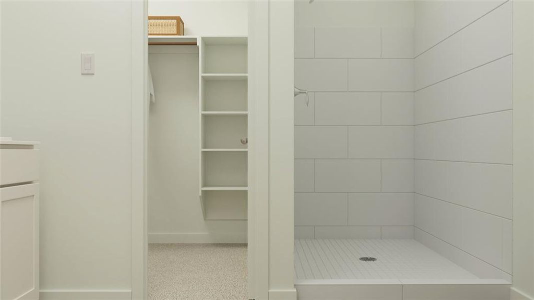 Bathroom with vanity and a tile shower