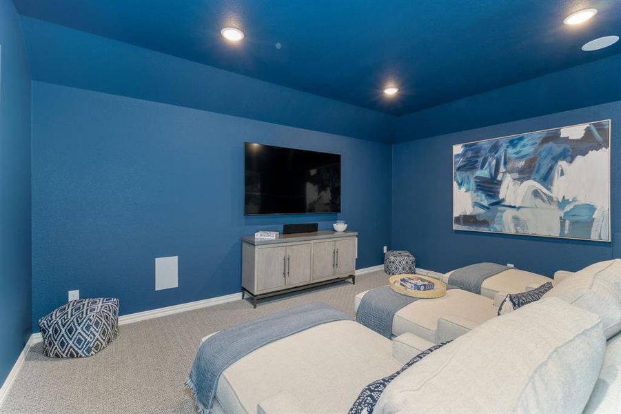 Home theater room featuring carpet