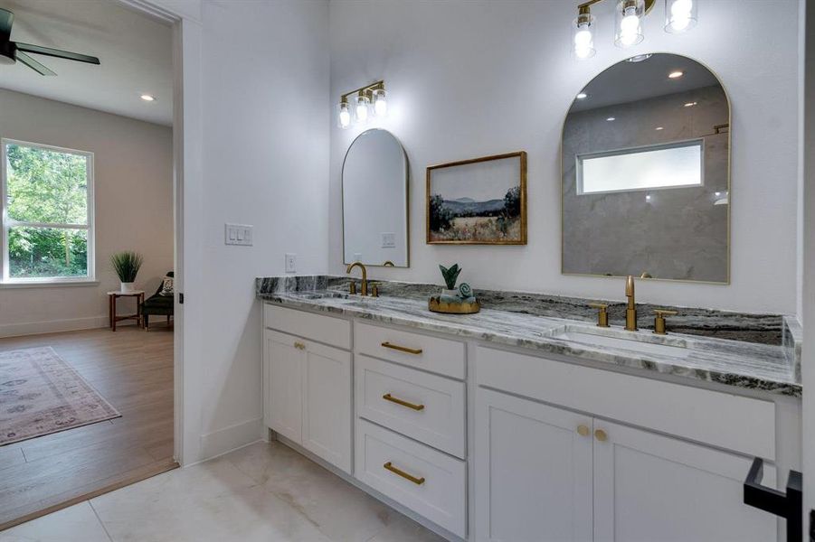 Bathroom with double sink vanity, hardwood / wood-style floors, and ceiling fan