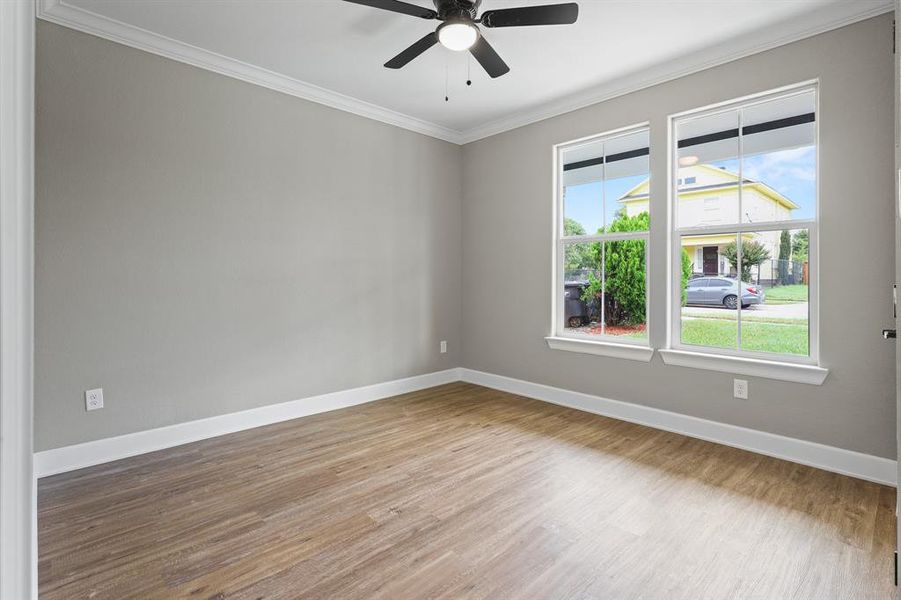 Unfurnished room with ornamental molding, ceiling fan, and hardwood / wood-style flooring