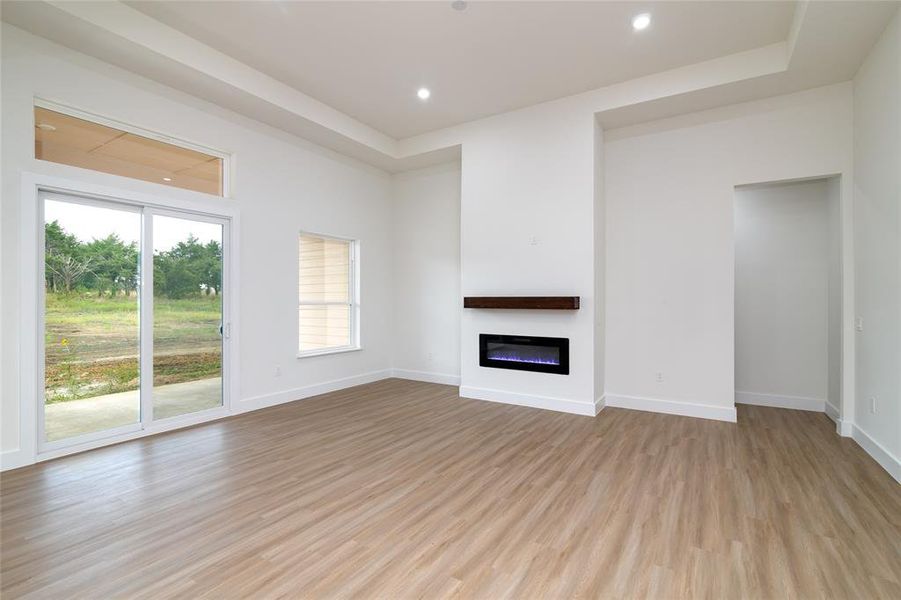 Unfurnished living room with light hardwood / wood-style floors