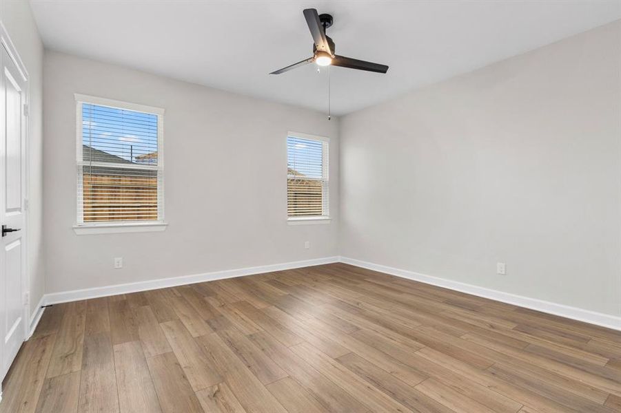 The primary bedroom has a lovely walk-in closet and two windows to let plenty of natural light in.