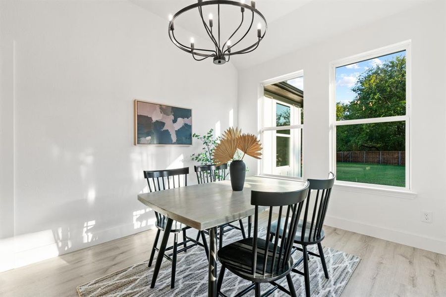 Dining room featuring light hardwood / wood-style floors and a notable chandelier