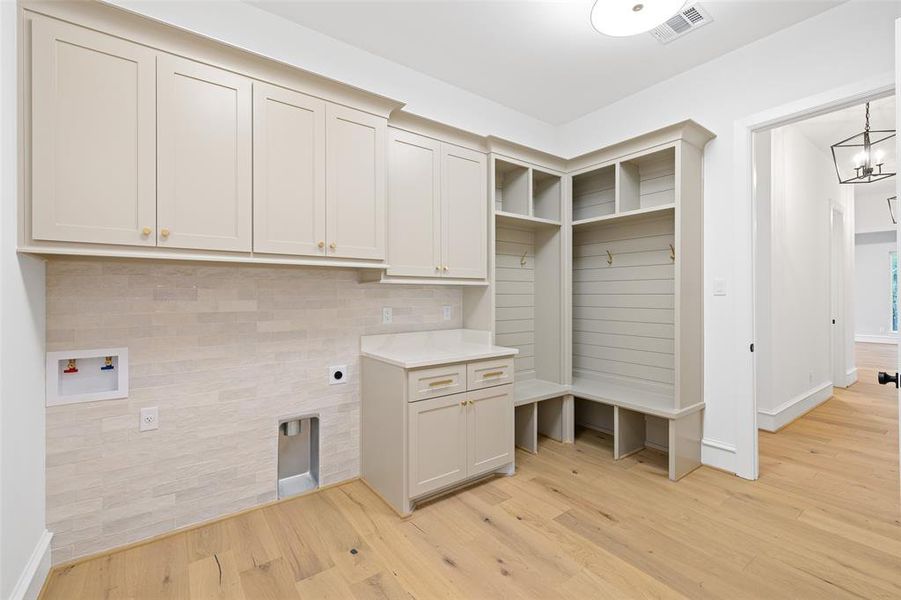 The laundry room includes an abundance of storage!