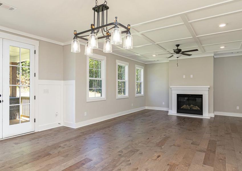 Angled view of the dining area and living room with wood flooring.