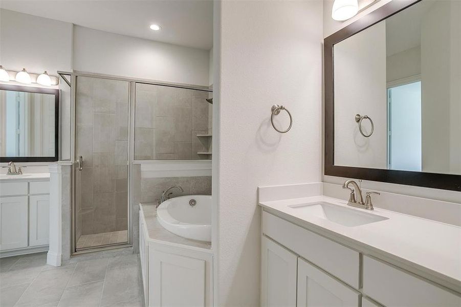 Bathroom with vanity, separate shower and tub, and tile patterned flooring