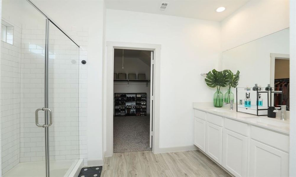 Primary bathroom has double sinks, large shower and attached to a large walk-in closet.