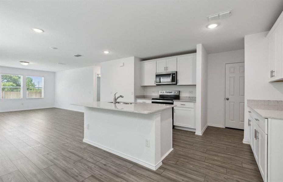 Airy kitchen with oversized island *real home pictured