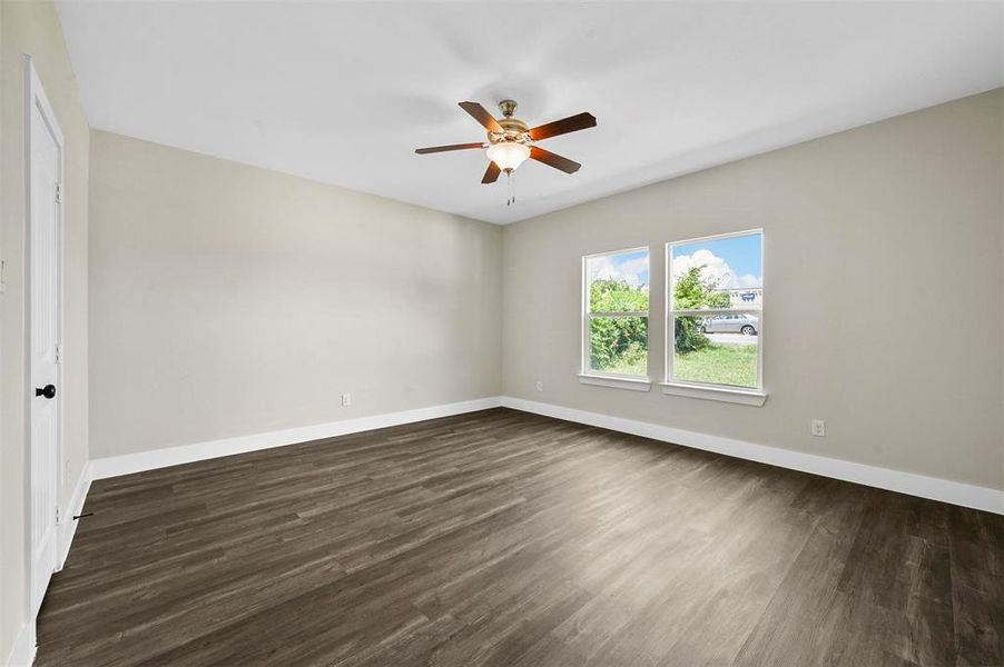 Spare room featuring ceiling fan and dark hardwood / wood-style floors