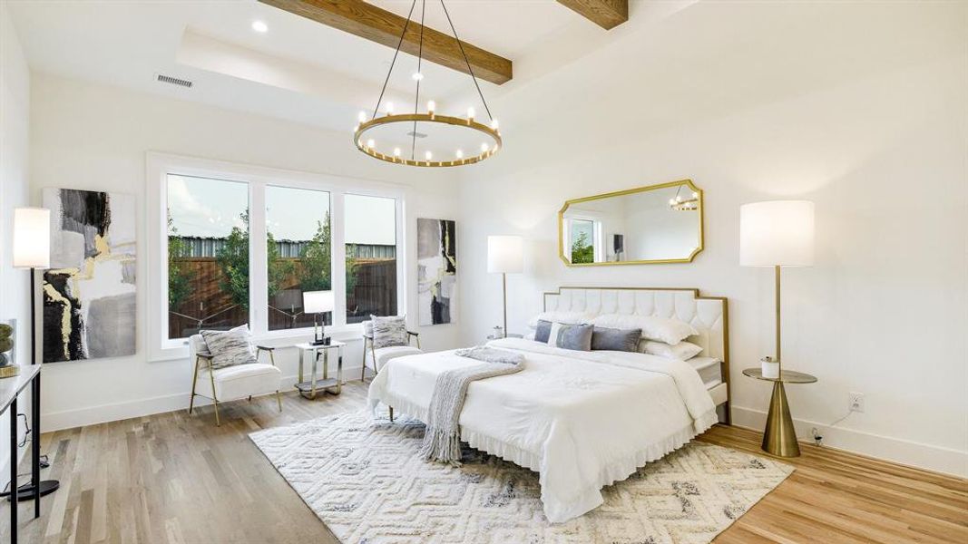 Bedroom featuring beamed ceiling, light wood-type flooring, and a chandelier