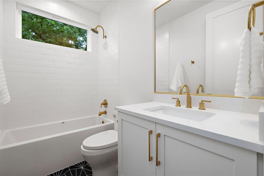 Secondary bathroom on first floor. Quartz countertops.