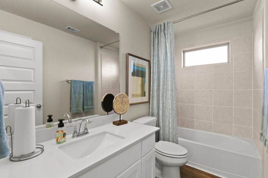 Bathroom in the Heisman home plan by Trophy Signature Homes – REPRESENTATIVE PHOTO
