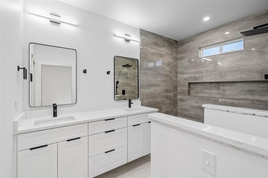 Bathroom with vanity and a tile shower