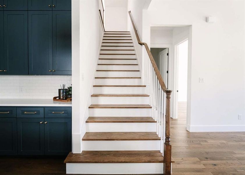 Stairway featuring wood-type flooring